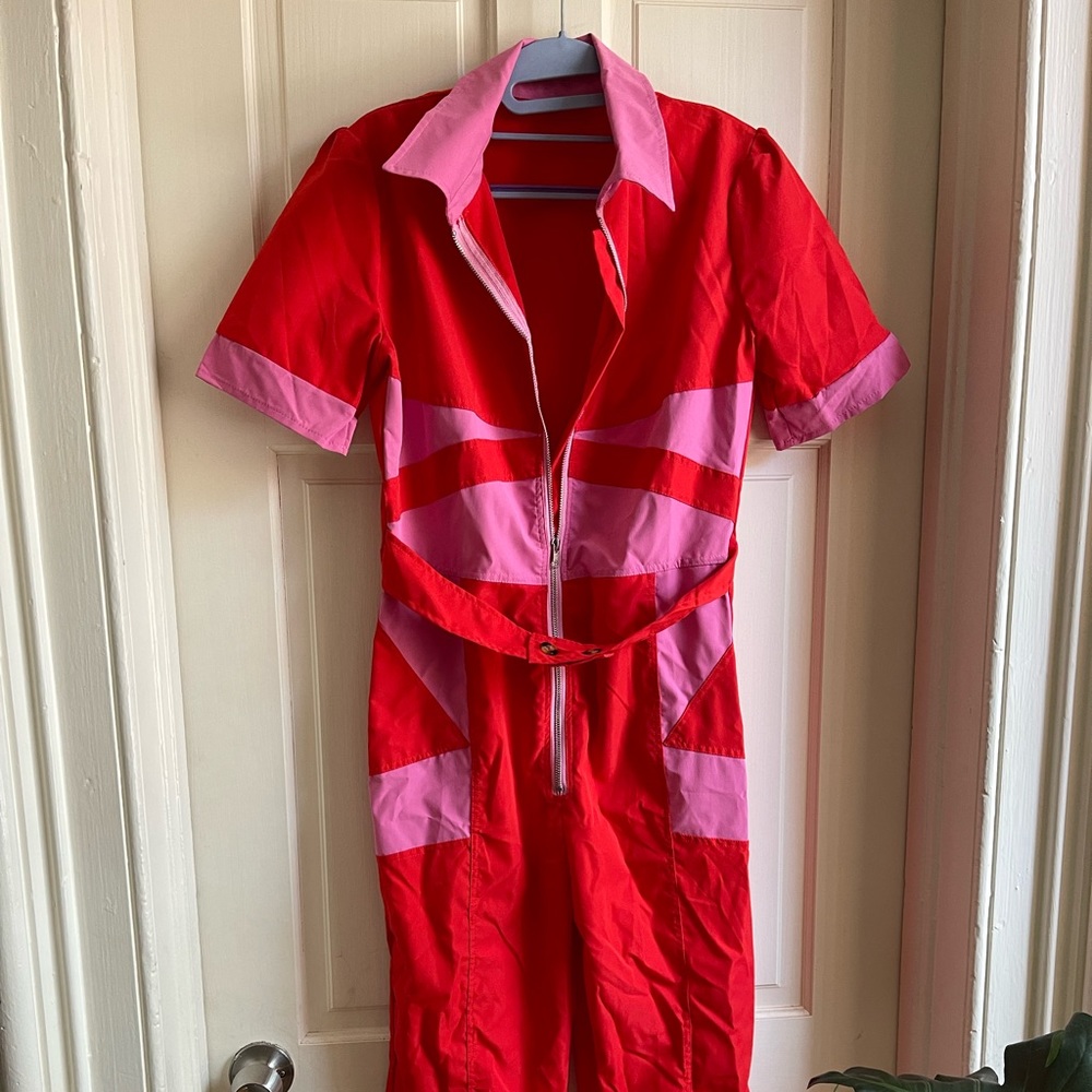 Super stylish and funky pink and red zip up romper.